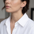 Woman wearing the Florence Baltic Honey Amber Earrings in Sterling Silver, showcasing genuine honey Baltic amber and polished 925 sterling silver in an elegant luxury jewelry lifestyle setting.