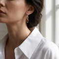 Woman wearing the Baltic Honey Amber Earrings in Sterling Silver, showcasing genuine honey Baltic amber and polished 925 sterling silver in an elegant luxury jewelry lifestyle setting.