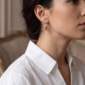Woman wearing the Julia Baltic Honey Amber Earrings in Sterling Silver, showcasing genuine honey Baltic amber and polished 925 sterling silver in an elegant luxury jewelry lifestyle setting.