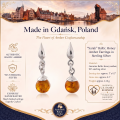 Sarah Baltic Honey Amber Earrings in Sterling Silver infographic highlighting authentic honey Baltic amber, 925 sterling silver, handcrafted craftsmanship, earring dimensions, and Made in Gdańsk, Poland heritage.