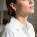 Woman wearing the Sarah Baltic Honey Amber Earrings in Sterling Silver, showcasing genuine honey Baltic amber and polished 925 sterling silver in an elegant luxury jewelry lifestyle setting.