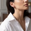 Woman wearing the Bethany Baltic Honey Amber Earrings in Sterling Silver, showcasing genuine honey Baltic amber and polished 925 sterling silver in an elegant luxury jewelry lifestyle setting.