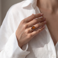 Woman wearing the GIA Certified Baltic Honey Amber Oval Ring in Sterling Silver, showcasing genuine oval honey Baltic amber, polished 925 sterling silver, and GIA-certified quality in an elegant luxury jewelry lifestyle setting.