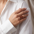 Woman wearing the Alexa Baltic Amber Ring in Sterling Silver, showcasing genuine Baltic amber and polished 925 sterling silver in an elegant luxury jewelry lifestyle setting.