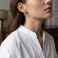 Woman wearing the Elegance Baltic Honey Amber Earrings in Sterling Silver, showcasing genuine honey Baltic amber and polished 925 sterling silver in an elegant luxury jewelry lifestyle setting.