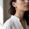 Woman wearing the June Baltic Amber Earrings in Sterling Silver, showcasing genuine Baltic amber and polished 925 sterling silver in an elegant luxury jewelry lifestyle setting.