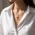 Woman wearing the Baltic Amber Cross Pendant Necklace in Sterling Silver, showcasing genuine Baltic amber and polished 925 sterling silver in an elegant luxury jewelry lifestyle setting.