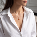 Woman wearing the Bethany Baltic Amber Pendant in Sterling Silver, showcasing genuine Baltic amber and polished 925 sterling silver in an elegant luxury jewelry lifestyle setting.