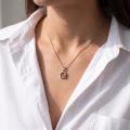 Woman wearing the Florence Baltic Honey Amber Pendant in Sterling Silver, showcasing genuine honey Baltic amber and polished 925 sterling silver in an elegant luxury jewelry lifestyle setting.