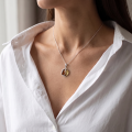 Woman wearing the Baltic Honey Amber Pendant in Sterling Silver, showcasing genuine honey Baltic amber and polished 925 sterling silver in an elegant luxury jewelry lifestyle setting.