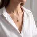 Woman wearing the Berry Baltic Honey Amber Pendant in Sterling Silver, showcasing genuine honey Baltic amber and polished 925 sterling silver in an elegant luxury jewelry lifestyle setting.