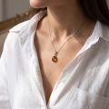 Woman wearing the Pendant with 18 Baltic Honey Amber Pendant Necklace in Sterling Silver, showcasing 18 genuine honey Baltic amber gemstones and polished 925 sterling silver in an elegant luxury jewelry lifestyle setting.