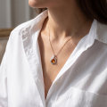 Woman wearing the Galaxy Baltic Honey Amber Pendant in Sterling Silver, showcasing genuine honey Baltic amber and polished 925 sterling silver in an elegant luxury jewelry lifestyle setting.