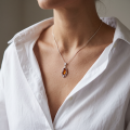 Woman wearing the Petal Baltic Honey Amber Pendant in Sterling Silver, showcasing genuine honey Baltic amber and polished 925 sterling silver in an elegant luxury jewelry lifestyle setting.