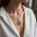Woman wearing the GIA Certified Baltic Amber Sun Pendant in Sterling Silver, showcasing genuine Baltic amber and polished 925 sterling silver in an elegant luxury jewelry lifestyle setting.