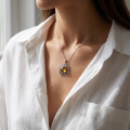 Woman wearing the Baltic Amber Sun Pendant in Sterling Silver, showcasing genuine Baltic amber and polished 925 sterling silver in an elegant luxury jewelry lifestyle setting.