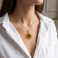 Woman wearing the Multicolor Baltic Amber Flower Pendant in Sterling Silver, showcasing genuine multicolor Baltic amber and polished 925 sterling silver in an elegant luxury jewelry lifestyle setting.