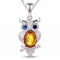 Owl Baltic Amber Pendant in Sterling Silver featuring genuine Baltic amber set in an owl-inspired polished 925 sterling silver design, isolated on a white background.