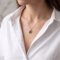 Woman wearing the Baltic Honey Amber Square Pendant in Sterling Silver, showcasing genuine honey Baltic amber and polished 925 sterling silver in an elegant luxury jewelry lifestyle setting.