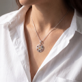 Woman wearing the Gale Multicolor Baltic Amber Pendant in Sterling Silver, showcasing genuine multicolor Baltic amber and polished 925 sterling silver in an elegant luxury jewelry lifestyle setting.