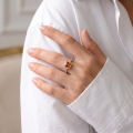 Woman wearing the Baltic Green Amber Square Ring in Sterling Silver, showcasing genuine green Baltic amber and polished 925 sterling silver in an elegant luxury jewelry lifestyle setting.