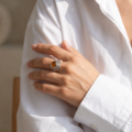 Woman wearing the Meadow Baltic Honey Amber Ring in Sterling Silver, showcasing genuine honey Baltic amber and polished 925 sterling silver in an elegant luxury jewelry lifestyle setting.