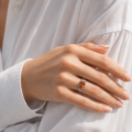 Woman wearing the Willow Baltic Honey Amber Ring in Sterling Silver, showcasing genuine honey Baltic amber and polished 925 sterling silver in an elegant luxury jewelry lifestyle setting.