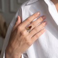 Woman wearing the April Multicolor Baltic Amber Ring in Sterling Silver, showcasing genuine multicolor Baltic amber and polished 925 sterling silver in an elegant luxury jewelry lifestyle setting.