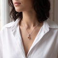 Woman wearing the Mona Baltic Honey Amber Pendant in Sterling Silver, showcasing genuine honey Baltic amber and polished 925 sterling silver in an elegant luxury jewelry lifestyle setting.