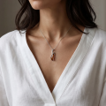 Woman wearing the Lena Baltic Honey Amber Pendant in Sterling Silver, showcasing genuine honey Baltic amber and polished 925 sterling silver in an elegant luxury jewelry lifestyle setting.