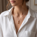 Woman wearing the Gianna Baltic Honey Amber Pendant in Sterling Silver, showcasing genuine honey Baltic amber and polished 925 sterling silver in an elegant luxury jewelry lifestyle setting.