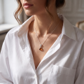Woman wearing the Agatha Baltic Honey Amber Pendant in Sterling Silver, showcasing genuine honey Baltic amber and polished 925 sterling silver in an elegant luxury jewelry lifestyle setting.