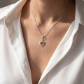 Woman wearing the Baltic Amber Star Pendant in Sterling Silver, showcasing genuine Baltic amber and polished 925 sterling silver in an elegant luxury jewelry lifestyle setting.