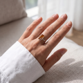 Woman wearing the Ninelle Baltic Honey Amber Ring in Sterling Silver, showcasing genuine honey Baltic amber and polished 925 sterling silver in an elegant luxury jewelry lifestyle setting.