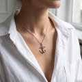 Woman wearing the Anchor Baltic Amber Pendant in Sterling Silver, showcasing genuine Baltic amber and polished 925 sterling silver in an elegant luxury jewelry lifestyle setting.