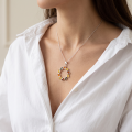 Woman wearing the Carrie Multicolor Baltic Amber Pendant in Sterling Silver, showcasing genuine multicolor Baltic amber and polished 925 sterling silver in an elegant luxury jewelry lifestyle setting.