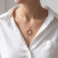 Woman wearing the Carrie Baltic Honey Amber Pendant in Sterling Silver, showcasing genuine honey Baltic amber and polished 925 sterling silver in an elegant luxury jewelry lifestyle setting.