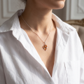 Woman wearing the Marisol Baltic Honey Amber Pendant in Sterling Silver, showcasing genuine honey Baltic amber and polished 925 sterling silver in an elegant luxury jewelry lifestyle setting.Woman wearing the Marisol Baltic Honey Amber Pendant in Sterling Silver, showcasing genuine honey Baltic amber and polished 925 sterling silver in an elegant luxury jewelry lifestyle setting.