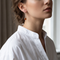 Woman wearing the Baltic Honey Amber Drop Earrings in Sterling Silver, showcasing genuine honey Baltic amber and polished 925 sterling silver in an elegant luxury jewelry lifestyle setting.