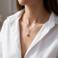 Woman wearing the Baltic Amber Pendant in Sterling Silver, showcasing genuine Baltic amber and polished 925 sterling silver in an elegant luxury jewelry lifestyle setting.