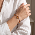 Aniela Baltic Honey Amber Bracelet in Sterling Silver infographic highlighting authentic honey Baltic amber, 925 sterling silver, handcrafted craftsmanship, bracelet dimensions, and Made in Gdańsk, Poland heritage.