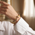 Woman wearing the Lily Baltic Amber Bracelet in Sterling Silver, showcasing genuine Baltic amber and polished 925 sterling silver in an elegant luxury jewelry lifestyle setting.