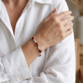 Woman wearing the Michelle Baltic Honey Amber Bracelet in Sterling Silver, showcasing genuine honey Baltic amber and polished 925 sterling silver in an elegant luxury jewelry lifestyle setting.