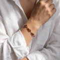 Woman wearing the Elena Baltic Honey Amber Bracelet in Sterling Silver, showcasing genuine honey Baltic amber and polished 925 sterling silver in an elegant luxury jewelry lifestyle setting.Woman wearing the Elena Baltic Honey Amber Bracelet in Sterling Silver, showcasing genuine honey Baltic amber and polished 925 sterling silver in an elegant luxury jewelry lifestyle setting.