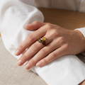 Woman wearing the Kayla Multicolor Baltic Amber Ring in Sterling Silver, showcasing genuine multicolor Baltic amber and polished 925 sterling silver in an elegant luxury jewelry lifestyle setting.