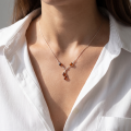 Woman wearing the Ines Baltic Honey Amber Necklace in Sterling Silver, showcasing genuine honey Baltic amber and polished 925 sterling silver in an elegant luxury jewelry lifestyle setting.