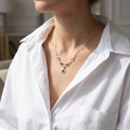Woman wearing the Lina Multicolor Baltic Amber Necklace in Sterling Silver, showcasing genuine multicolor Baltic amber and polished 925 sterling silver in an elegant luxury jewelry lifestyle setting.