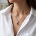 Woman wearing the Baltic Honey Amber Heart Pendant in Sterling Silver, showcasing genuine honey Baltic amber and polished 925 sterling silver in an elegant luxury jewelry lifestyle setting.
