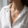 Woman wearing the Wisdom Tree Multicolor Baltic Amber Pendant in Sterling Silver, showcasing genuine multicolor Baltic amber and polished 925 sterling silver in an elegant luxury jewelry lifestyle setting.