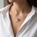 Woman wearing the Multicolor Baltic Amber Heart Necklace in Sterling Silver, showcasing genuine multicolor Baltic amber and polished 925 sterling silver in an elegant luxury jewelry lifestyle setting.